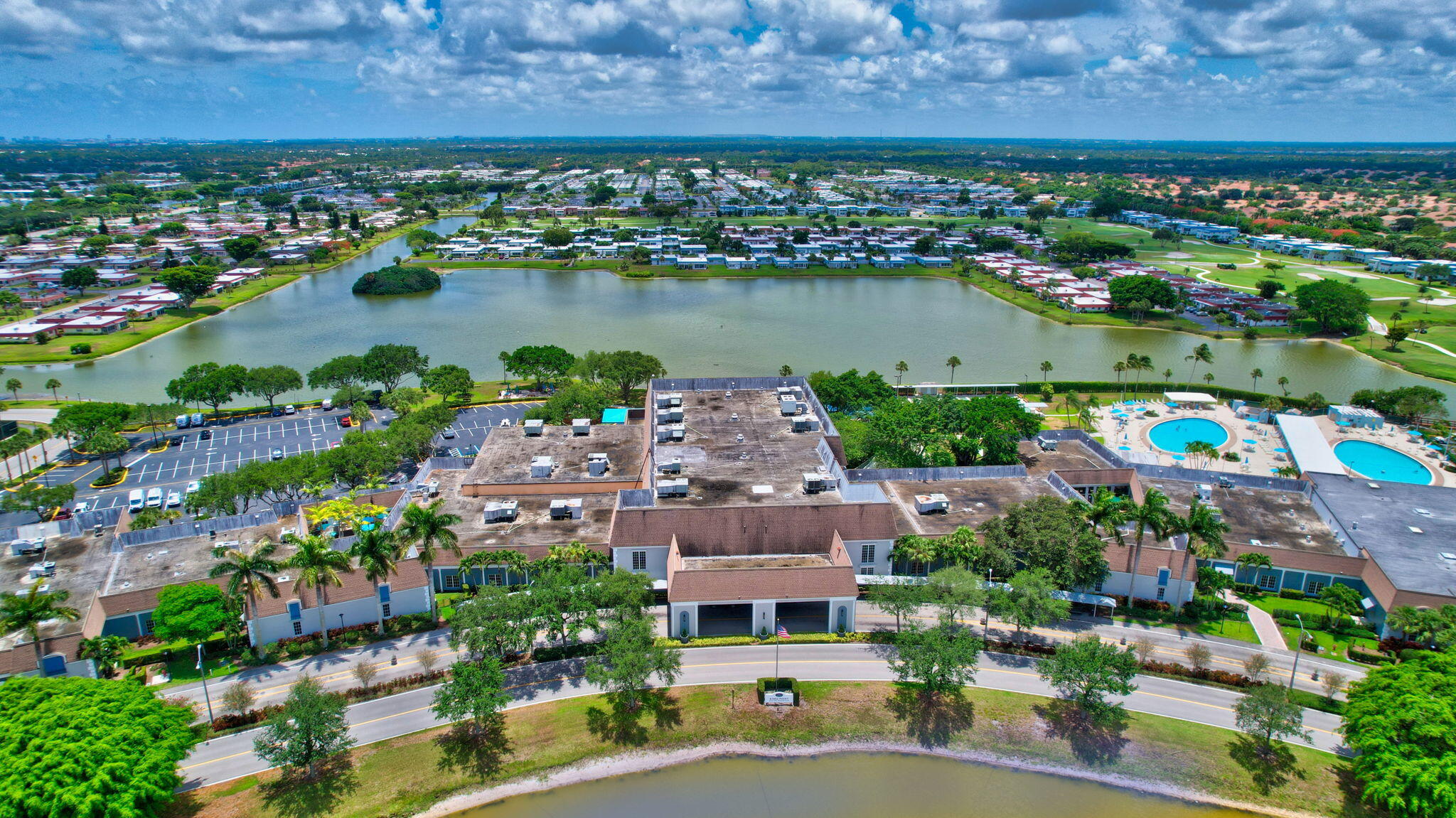 an aerial view of a city with lots of residential buildings lake and ocean view