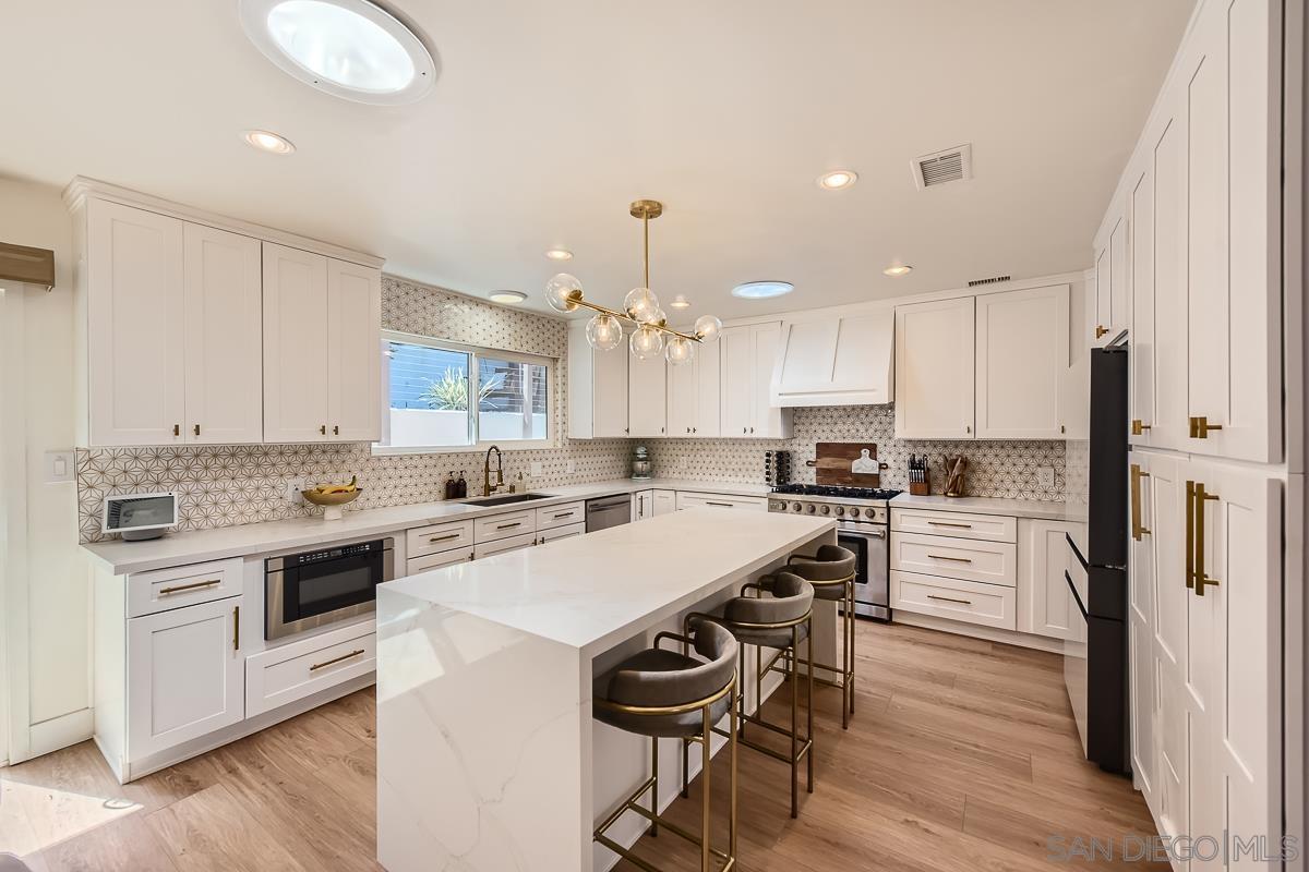 a kitchen with a stove a sink and a refrigerator