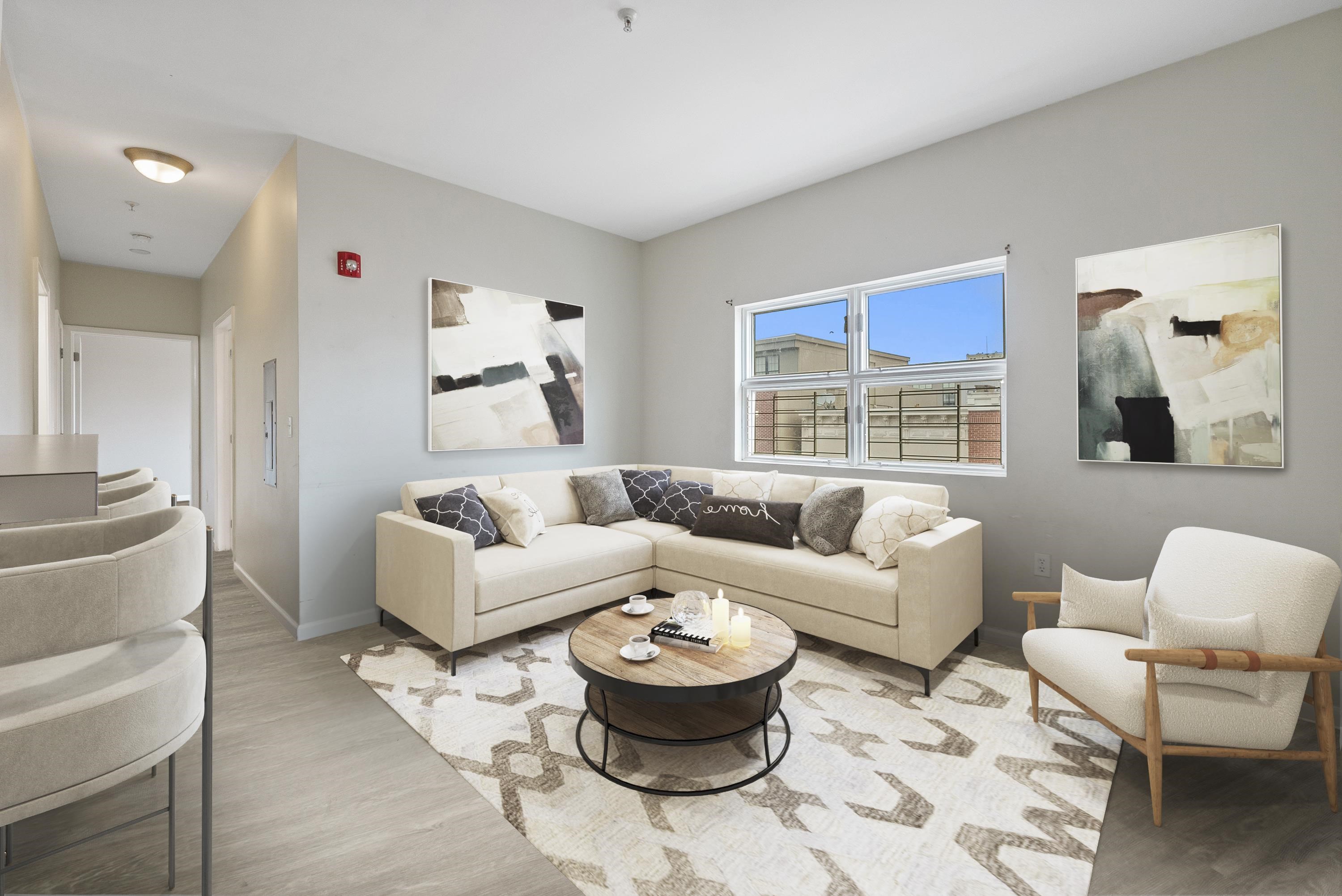 a living room with furniture and a large window