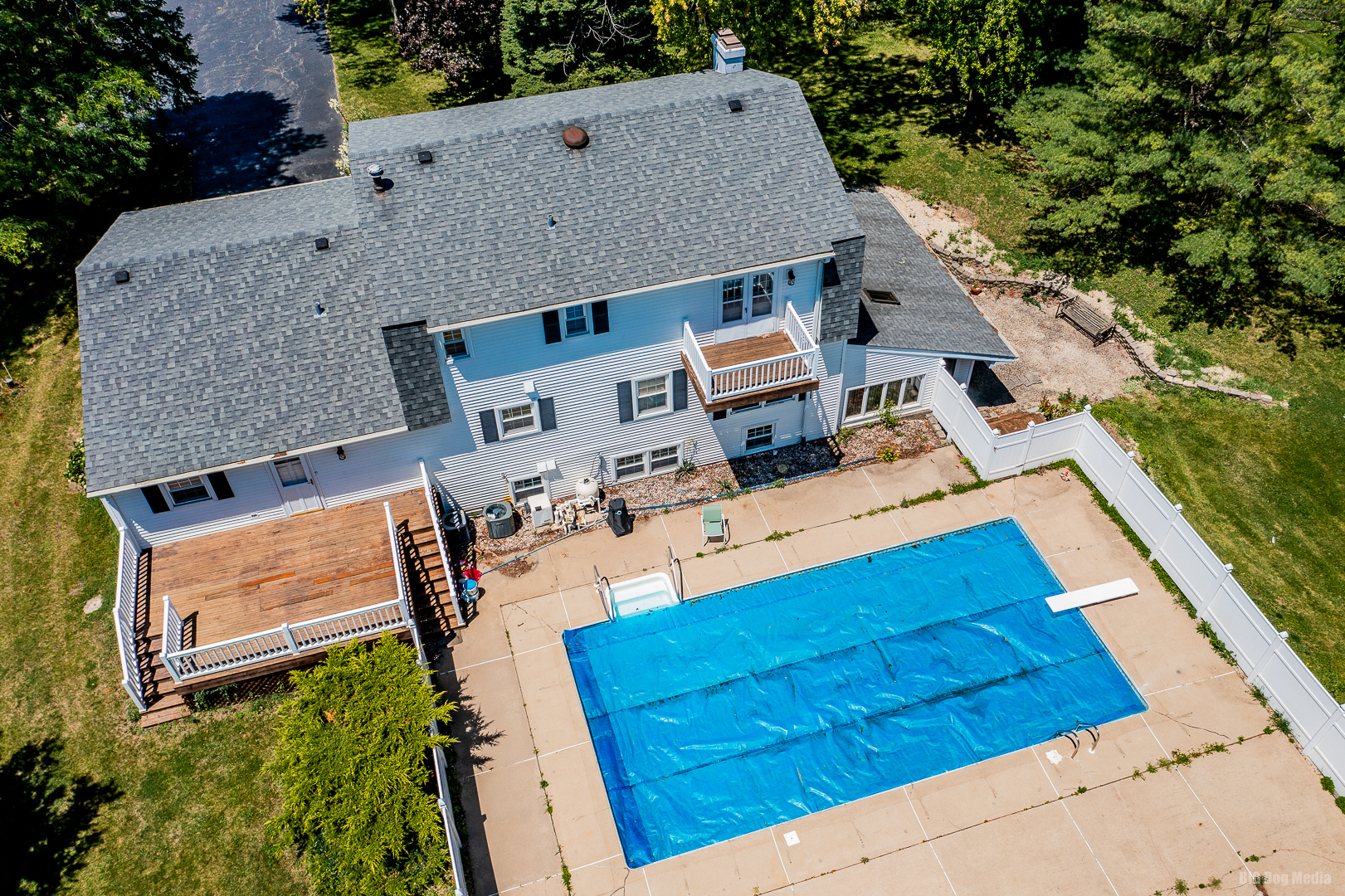 an aerial view of a house with a yard basket ball court and outdoor seating