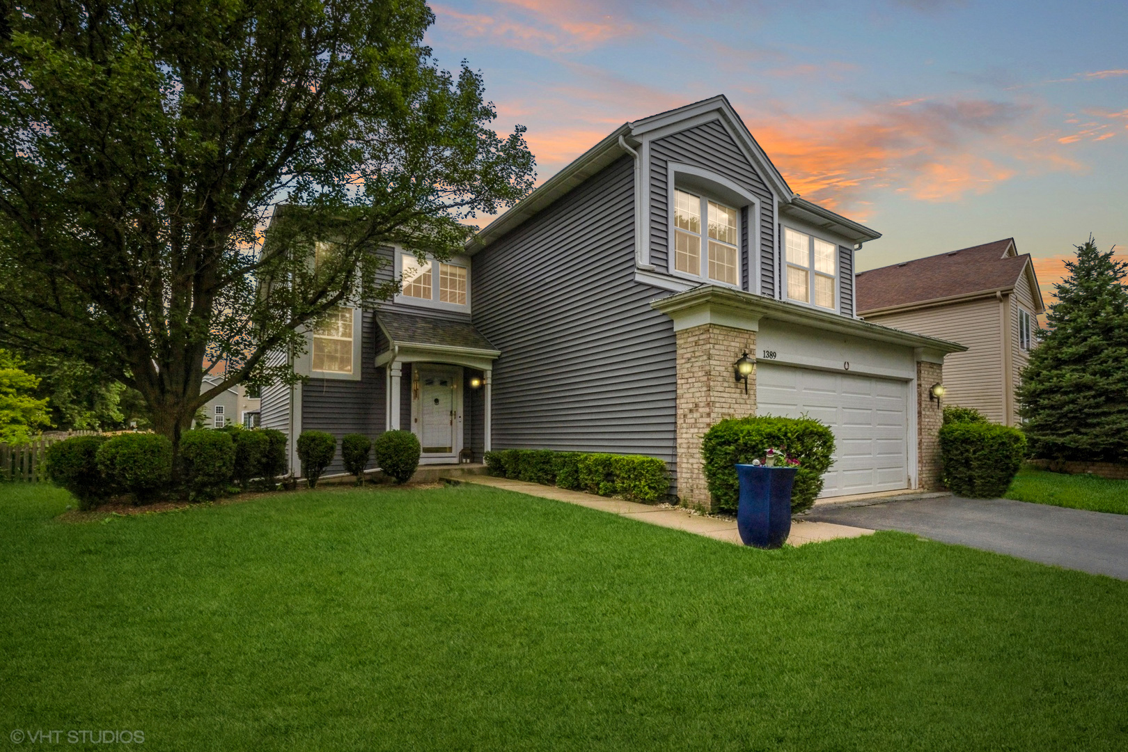 a front view of a house with a garden