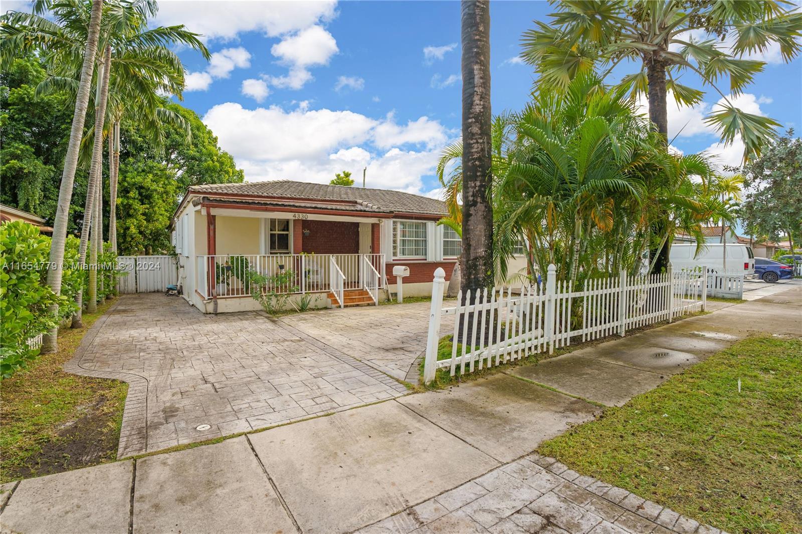 a view of a house with a small yard and plants