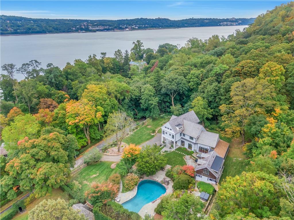 an aerial view of a house with a lake view