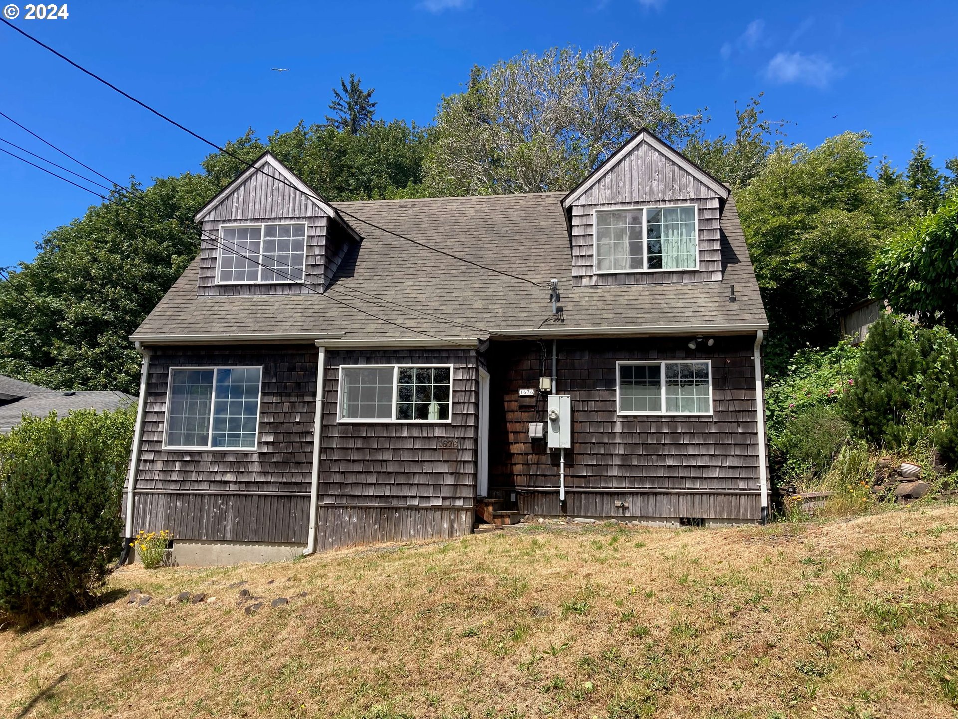 a front view of a house with a yard