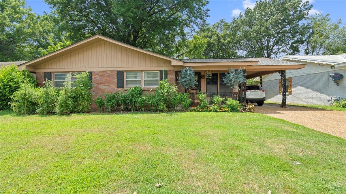 a front view of a house with a yard and porch