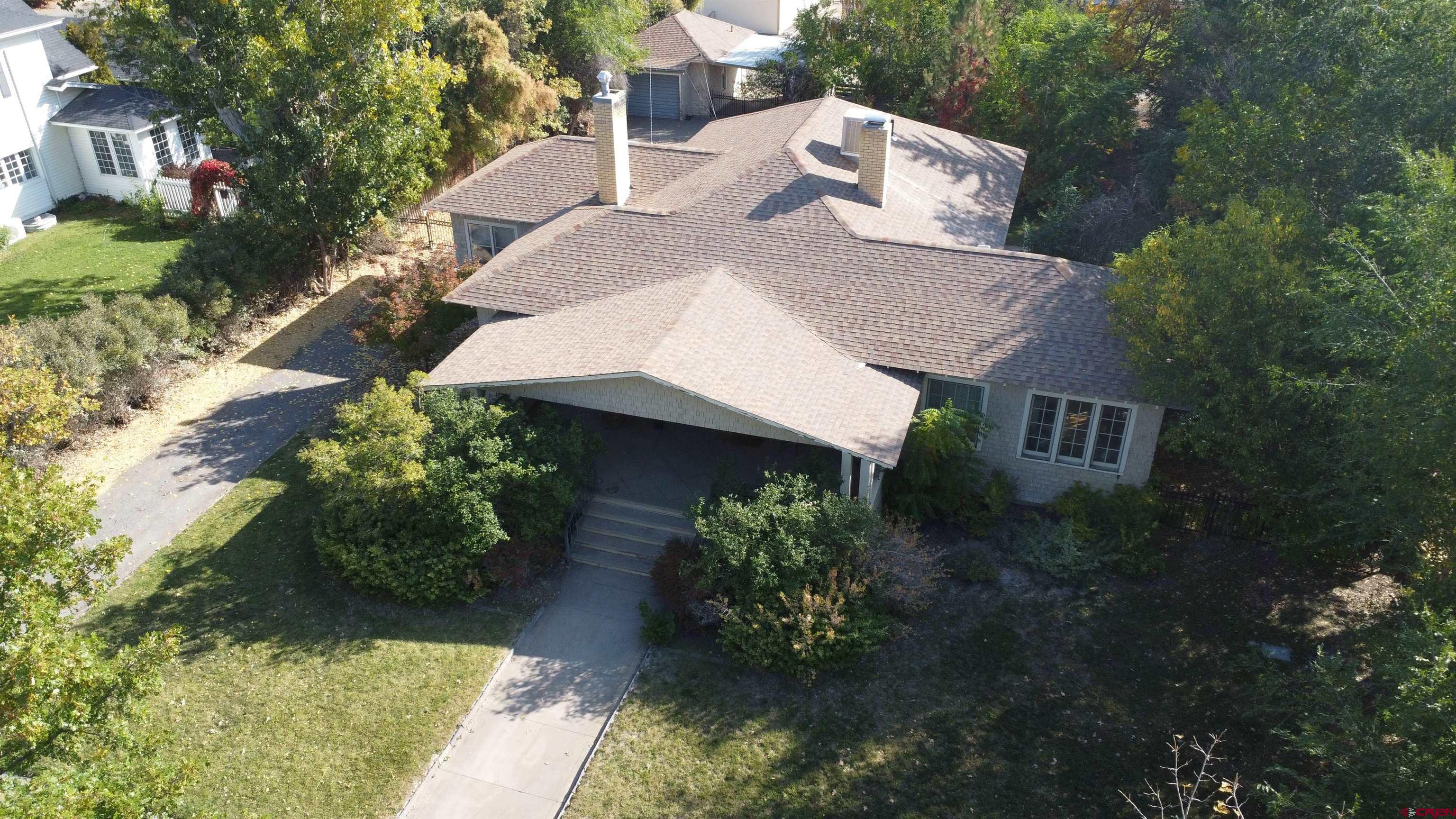 a view of a house with a yard and a garden