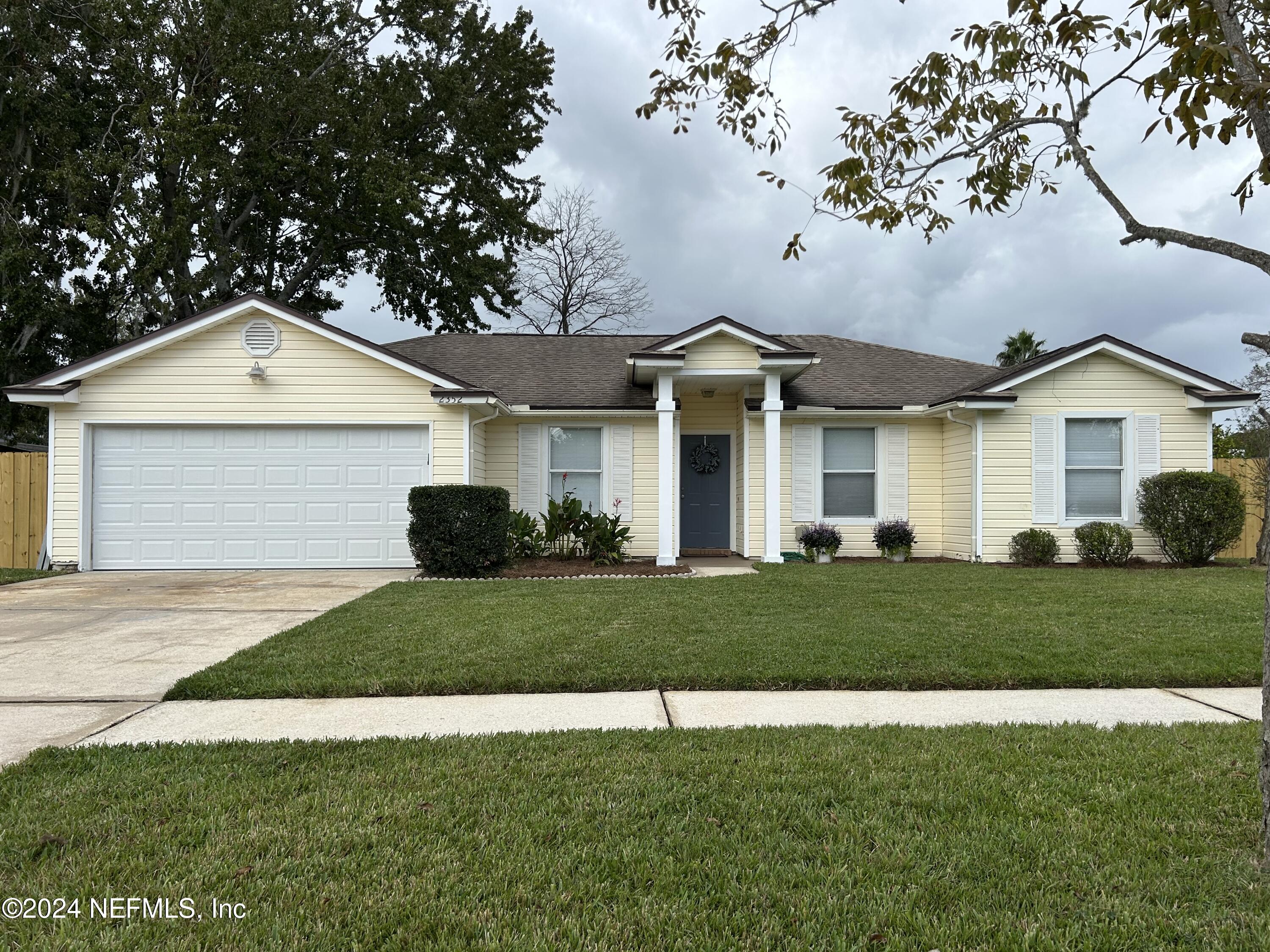 a front view of a house with a yard