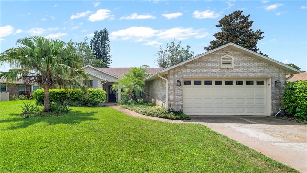 a front view of a house with a yard and garage