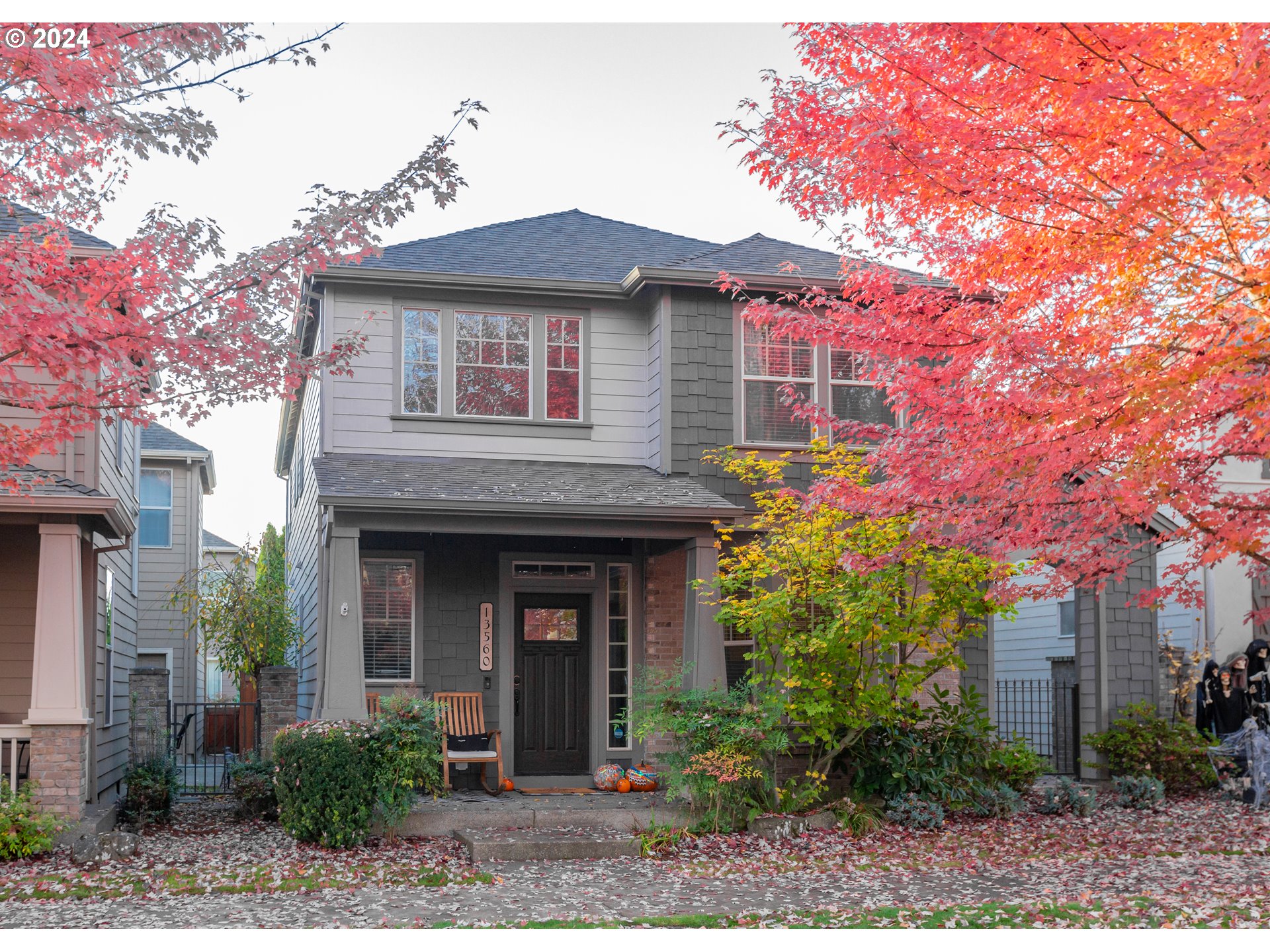 a front view of a house with plants