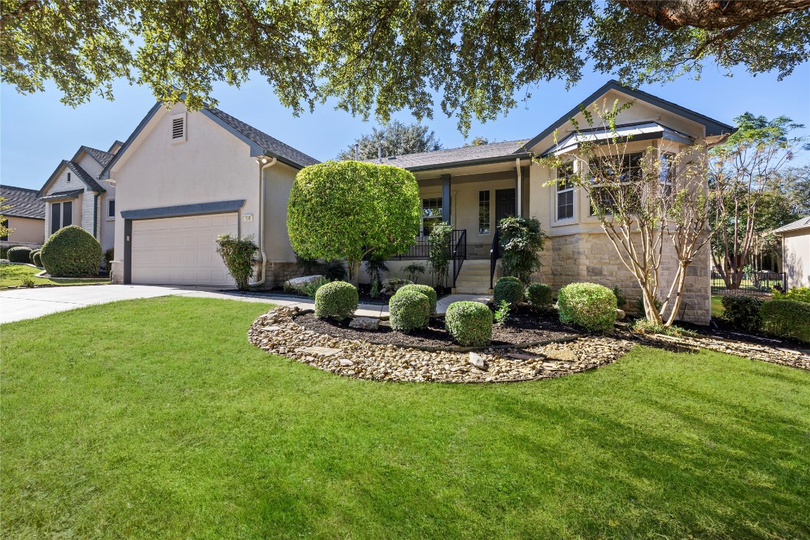 a front view of a house with a yard and porch