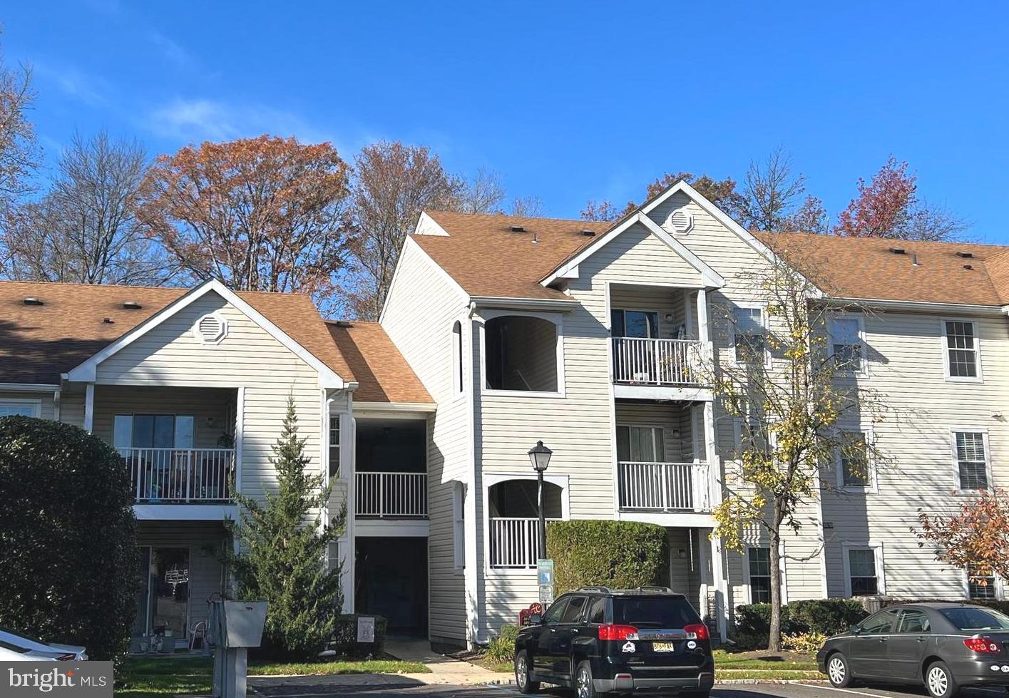 a front view of a residential apartment building with a yard