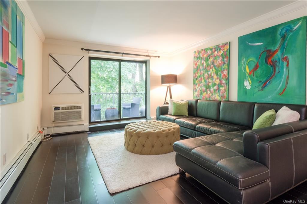 Graciously sized living room with sliding glass doors to large tranquil terrace