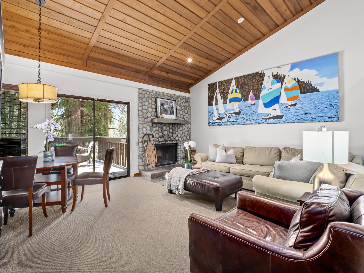 a living room with furniture a fireplace and a table