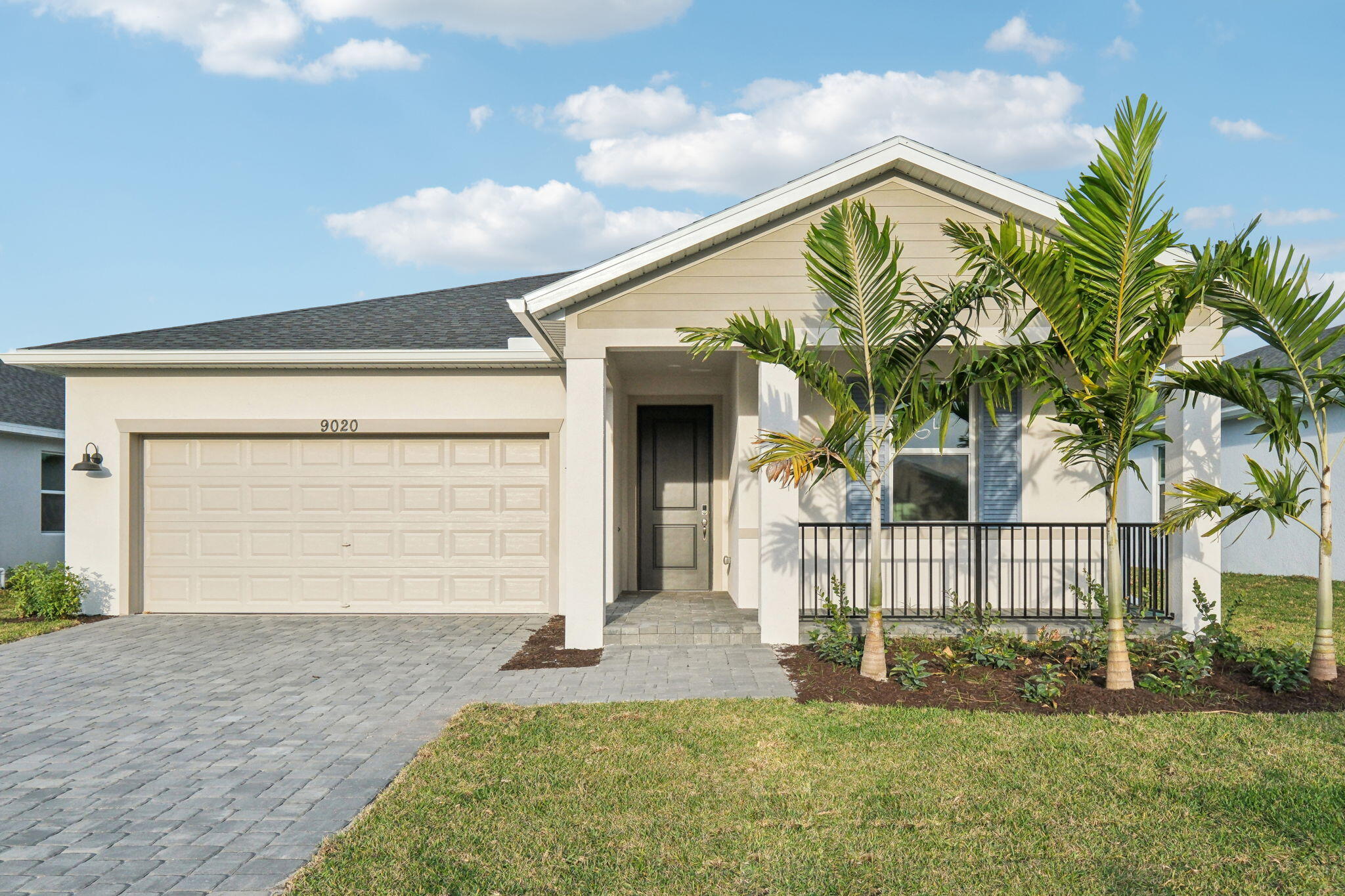 a front view of a house with a garden and entryway