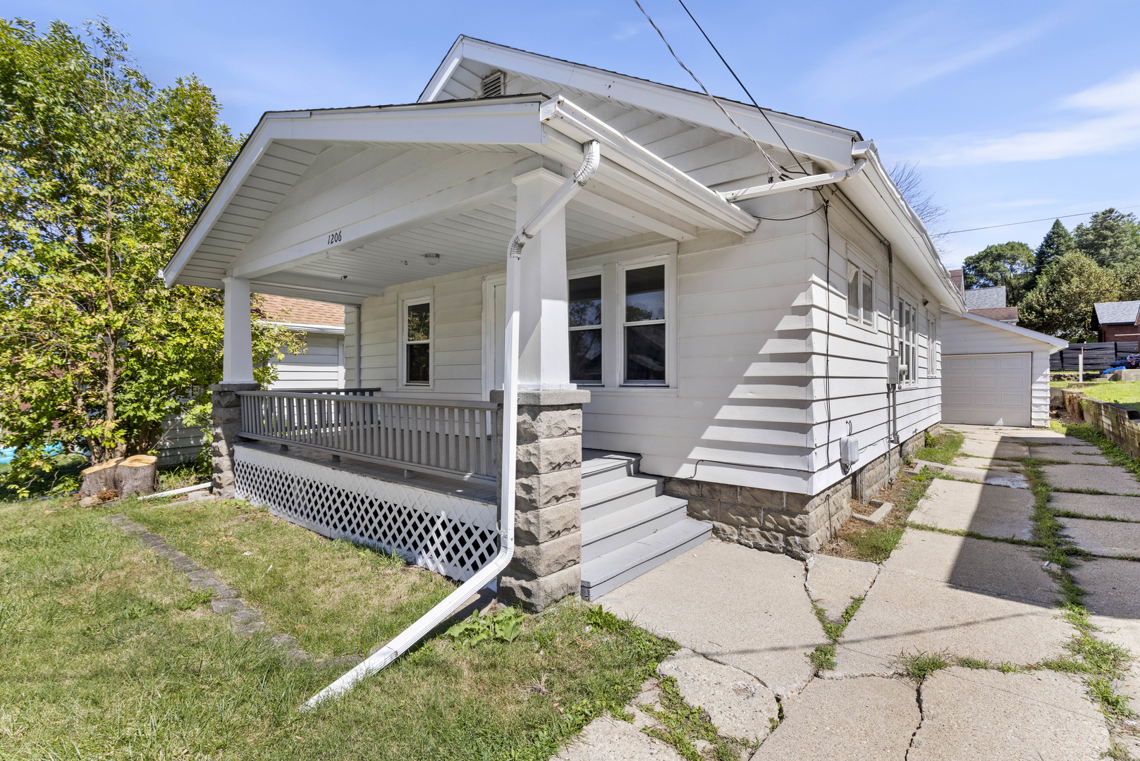 a view of a house with wooden floor next to a yard