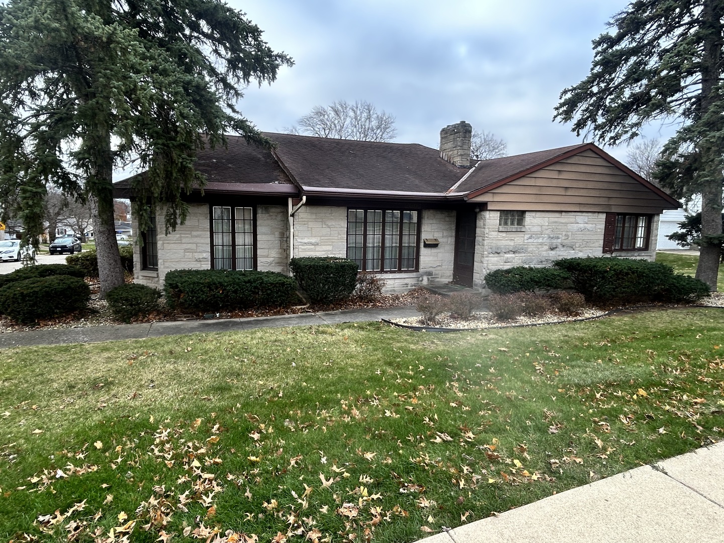 a front view of a house with a yard and potted plants