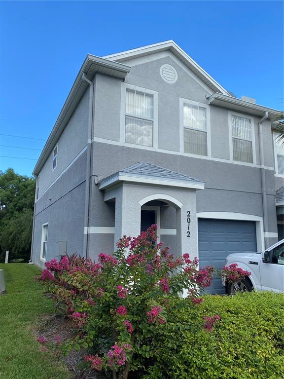 a front view of house with a garden