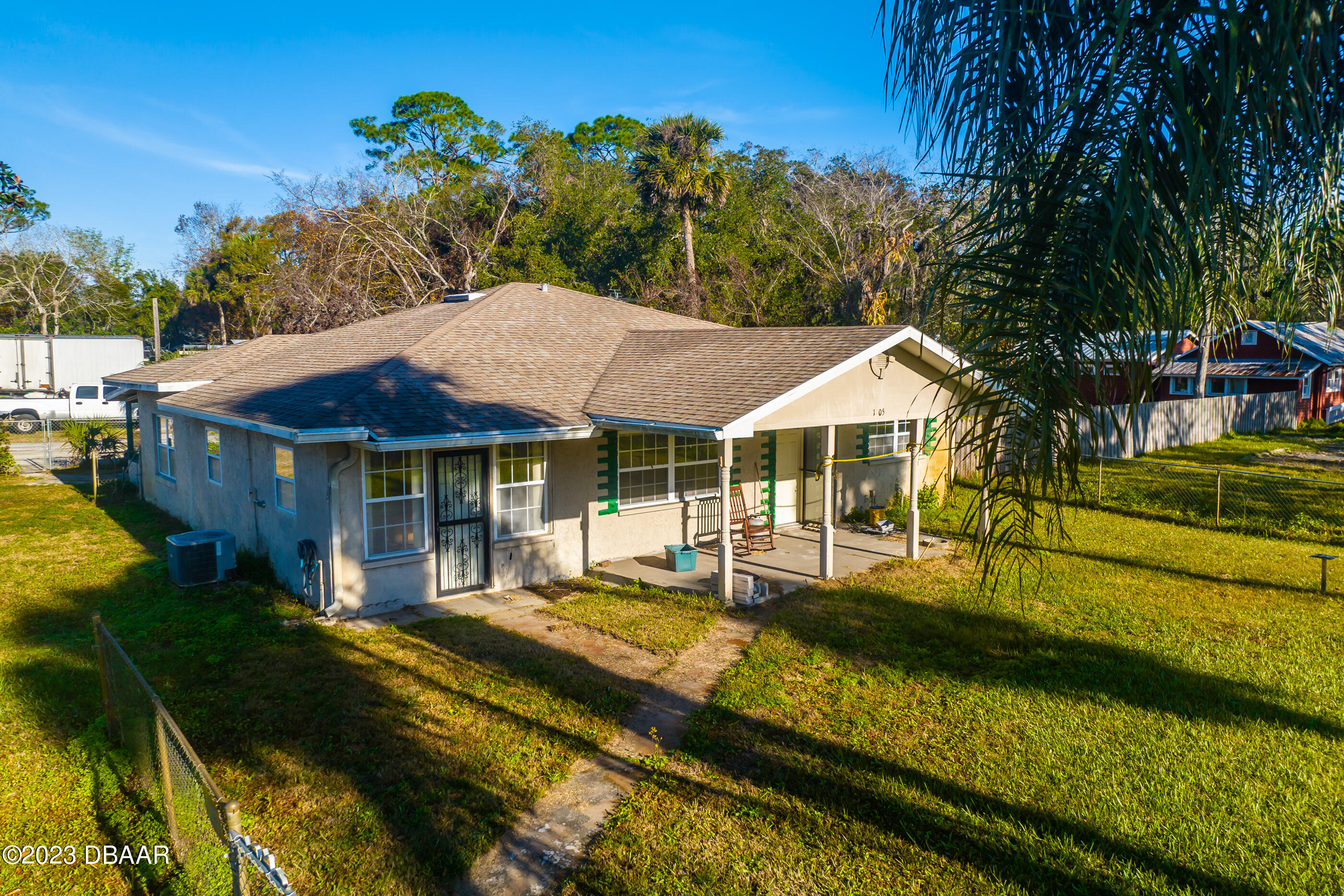 a view of a house with swimming pool and next to a yard