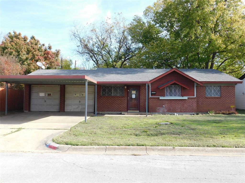 Ranch-style home with a front lawn, a garage, and a carport