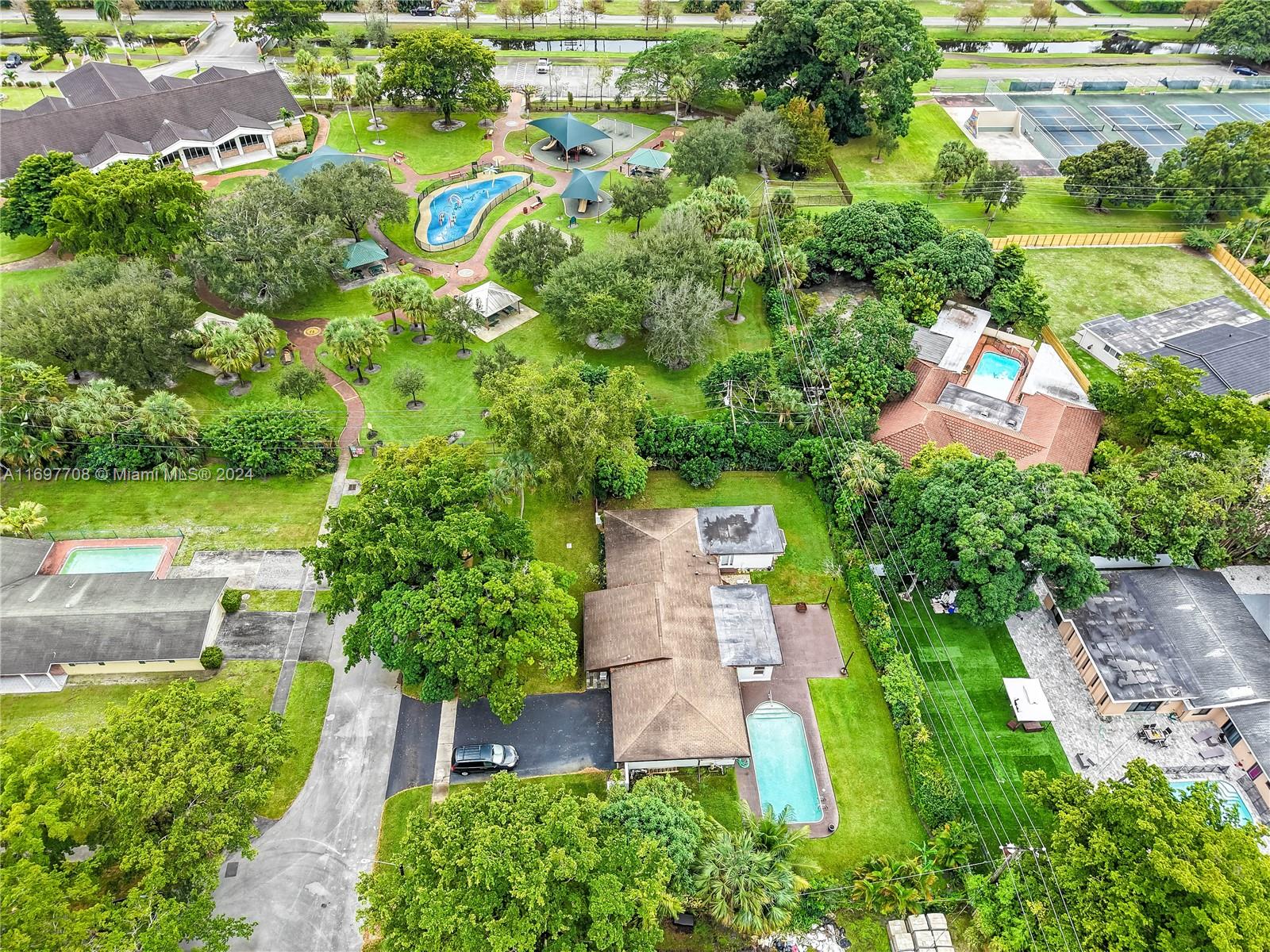 an aerial view of a house with a yard and lake view