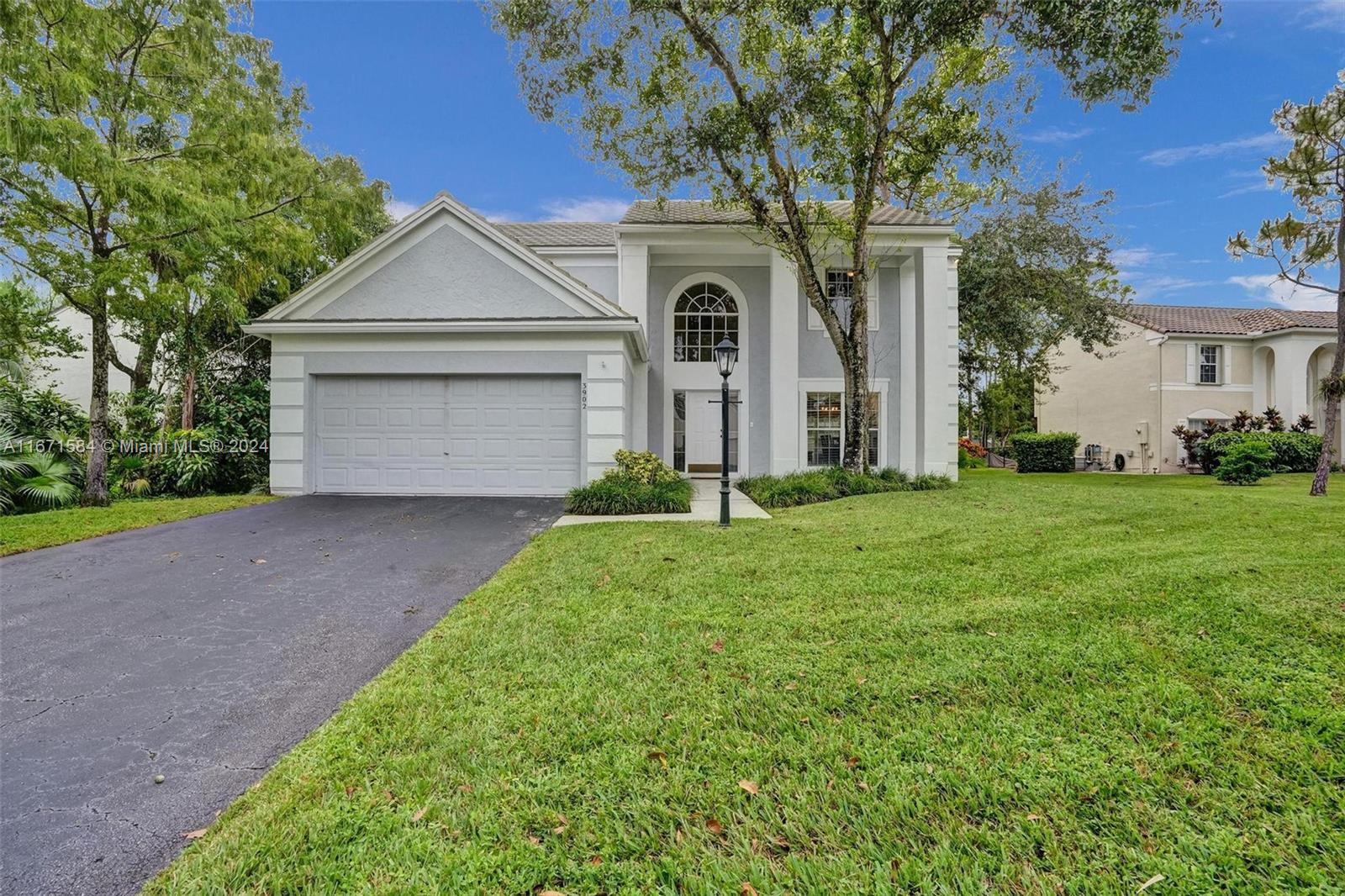 a front view of a house with a yard and garage