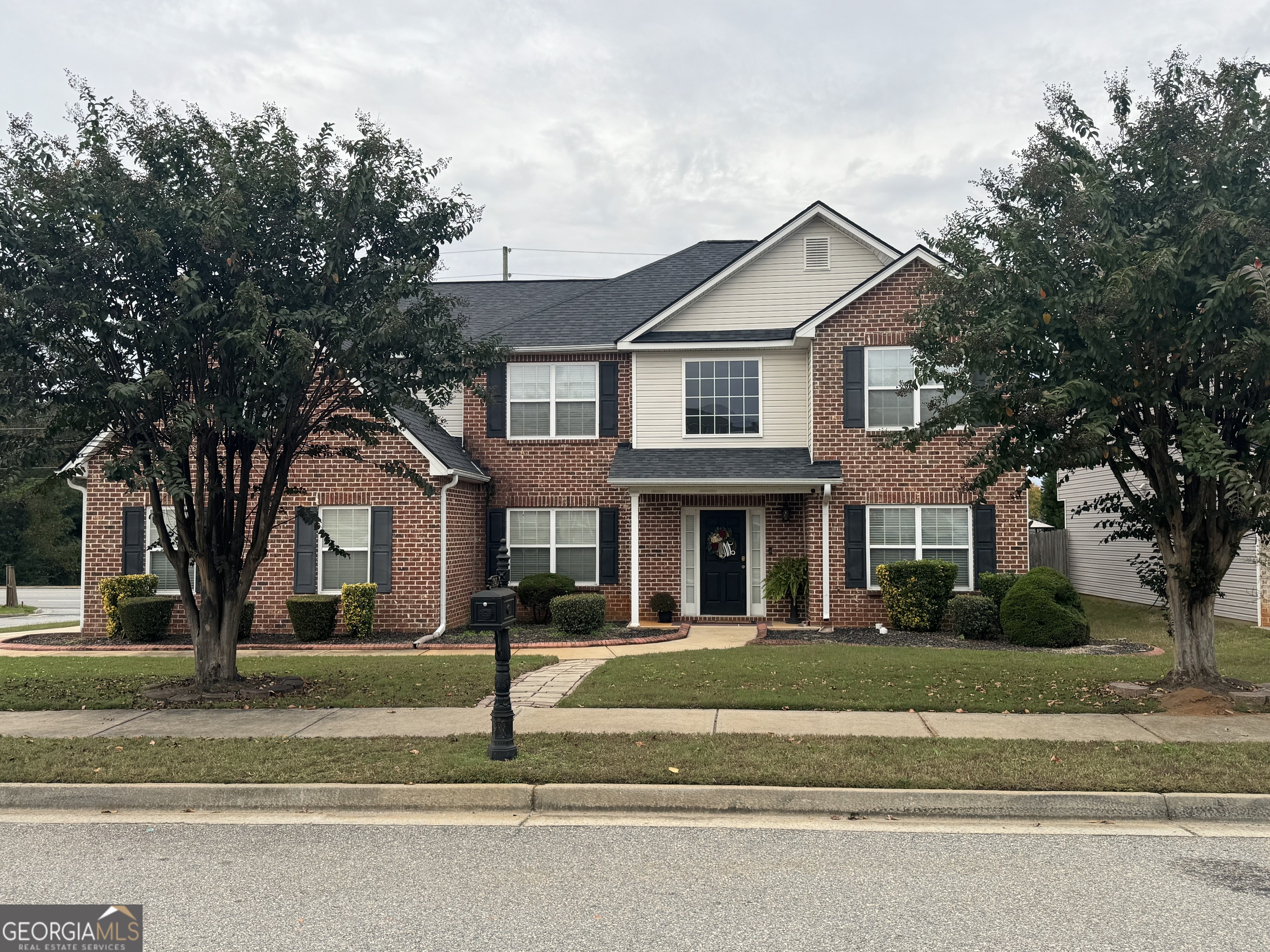 a front view of a house with a yard