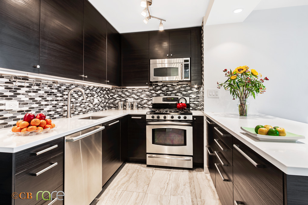 a kitchen with stainless steel appliances a stove a sink and a microwave