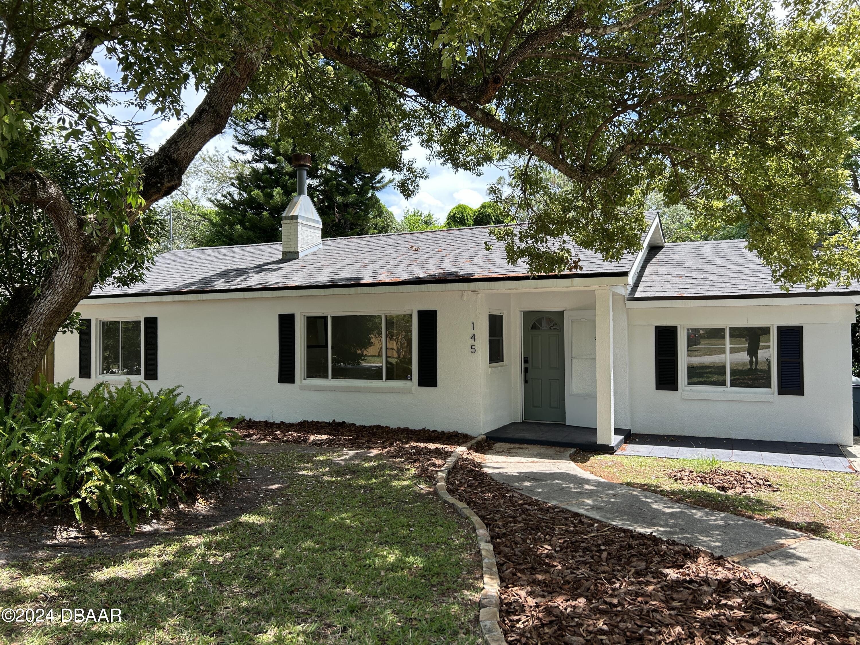 a front view of a house with yard