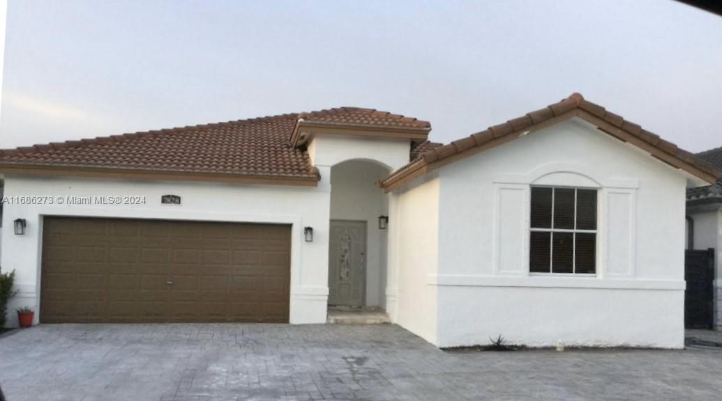 a front view of a house with garage