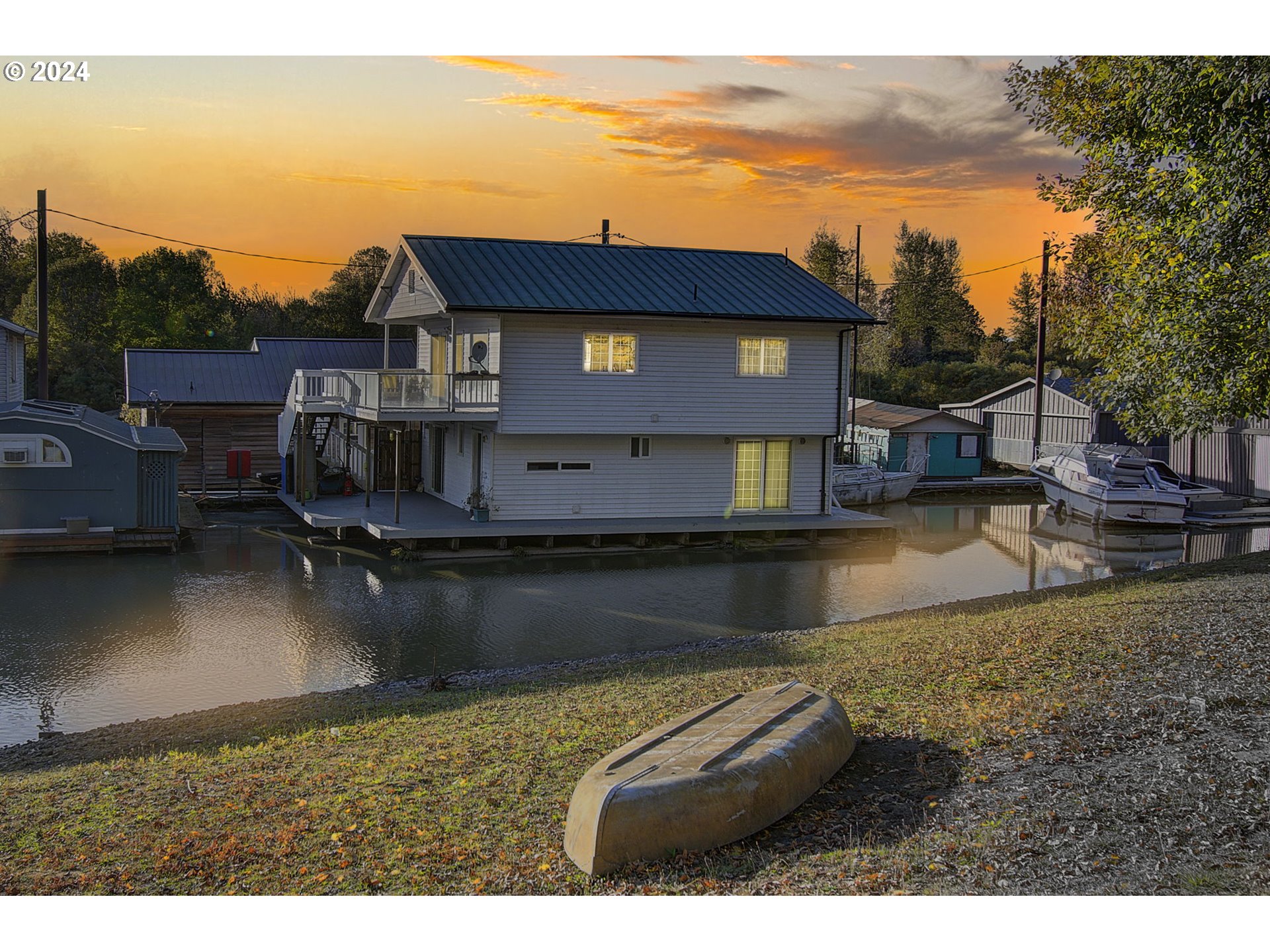 a view of a house with pool and lake view