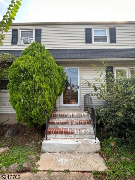 a view of a house with potted plants