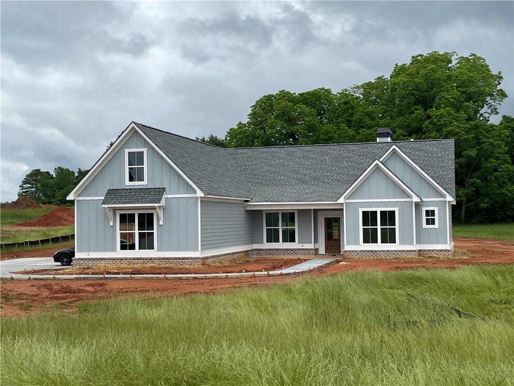 a front view of house with yard and green space