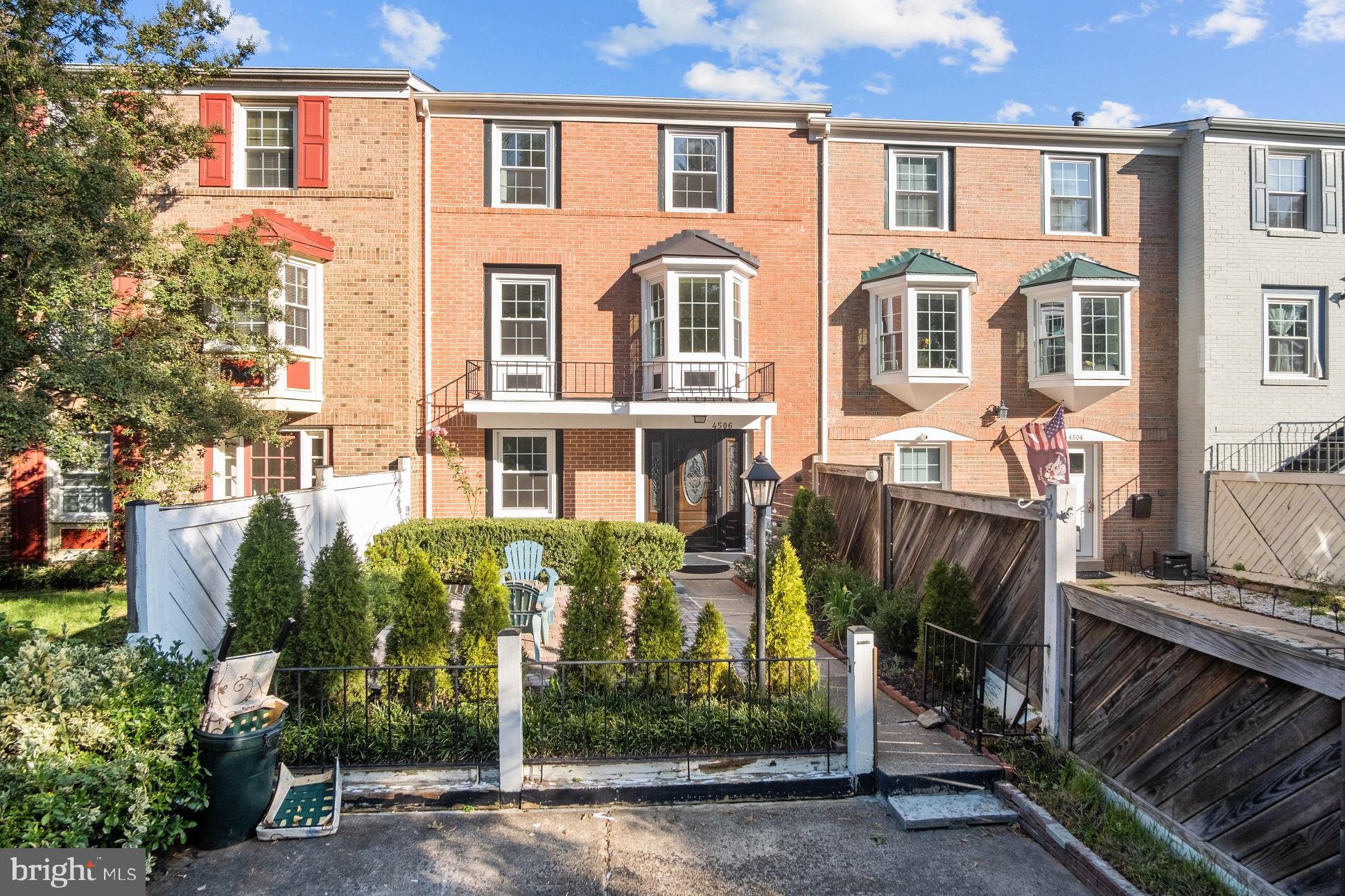 a front view of a residential apartment building with a yard