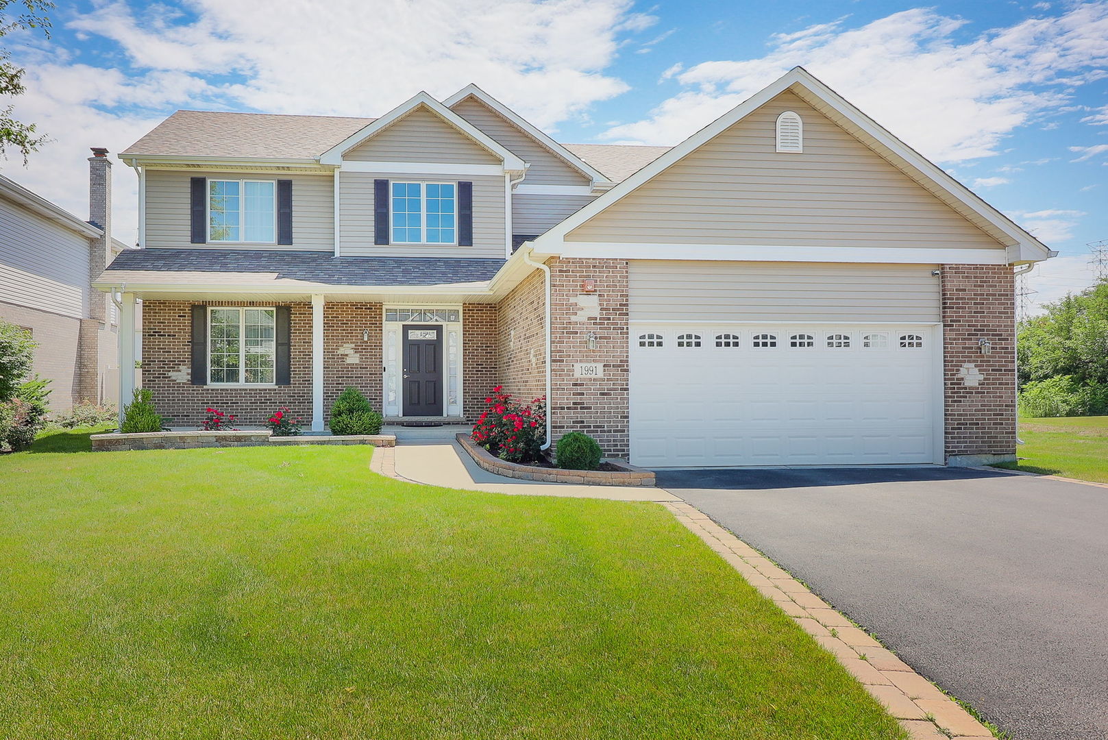 a front view of a house with a yard and garage