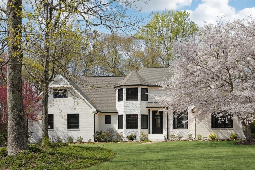 a front view of a house with a garden