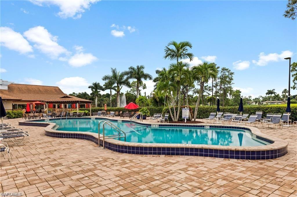 a view of a house with swimming pool and a yard