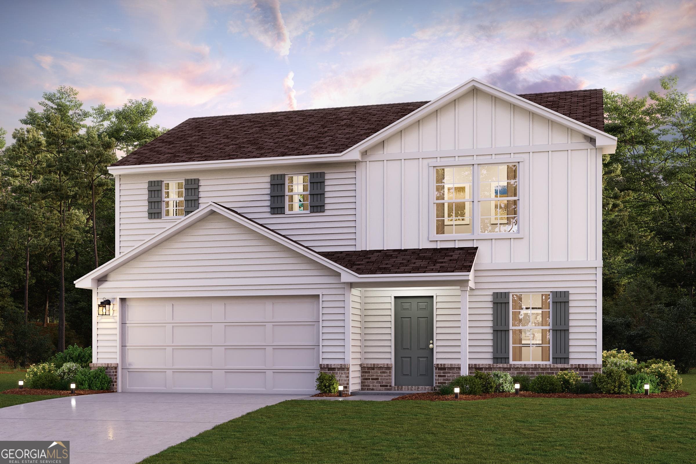 a front view of a house with a yard and garage