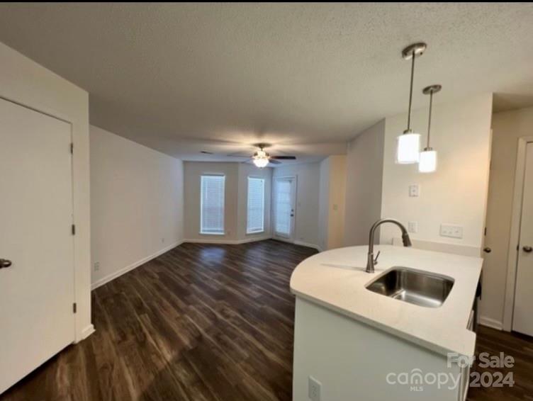 a kitchen with a sink and chandelier