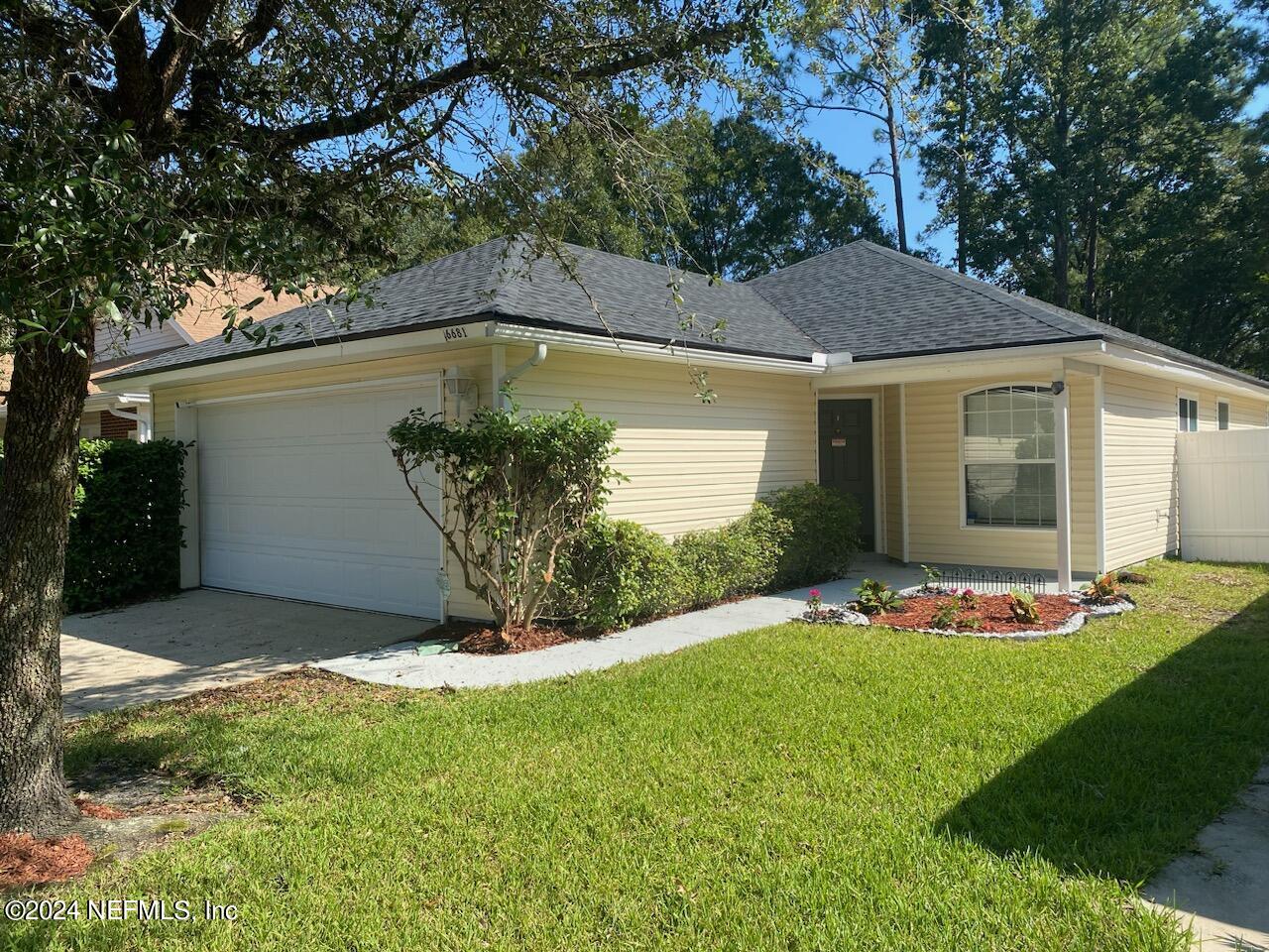 a view of an house with backyard space and garden