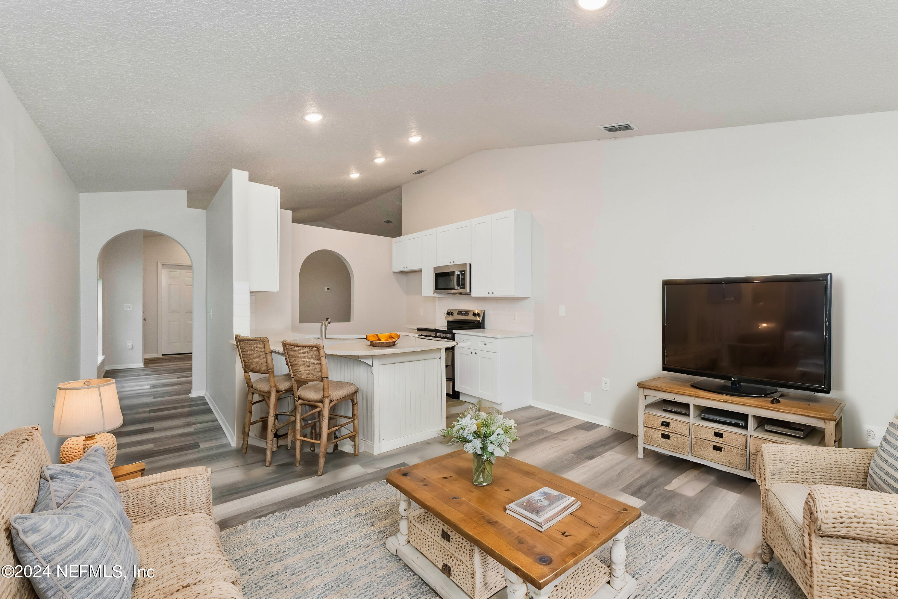 a living room with furniture and a flat screen tv