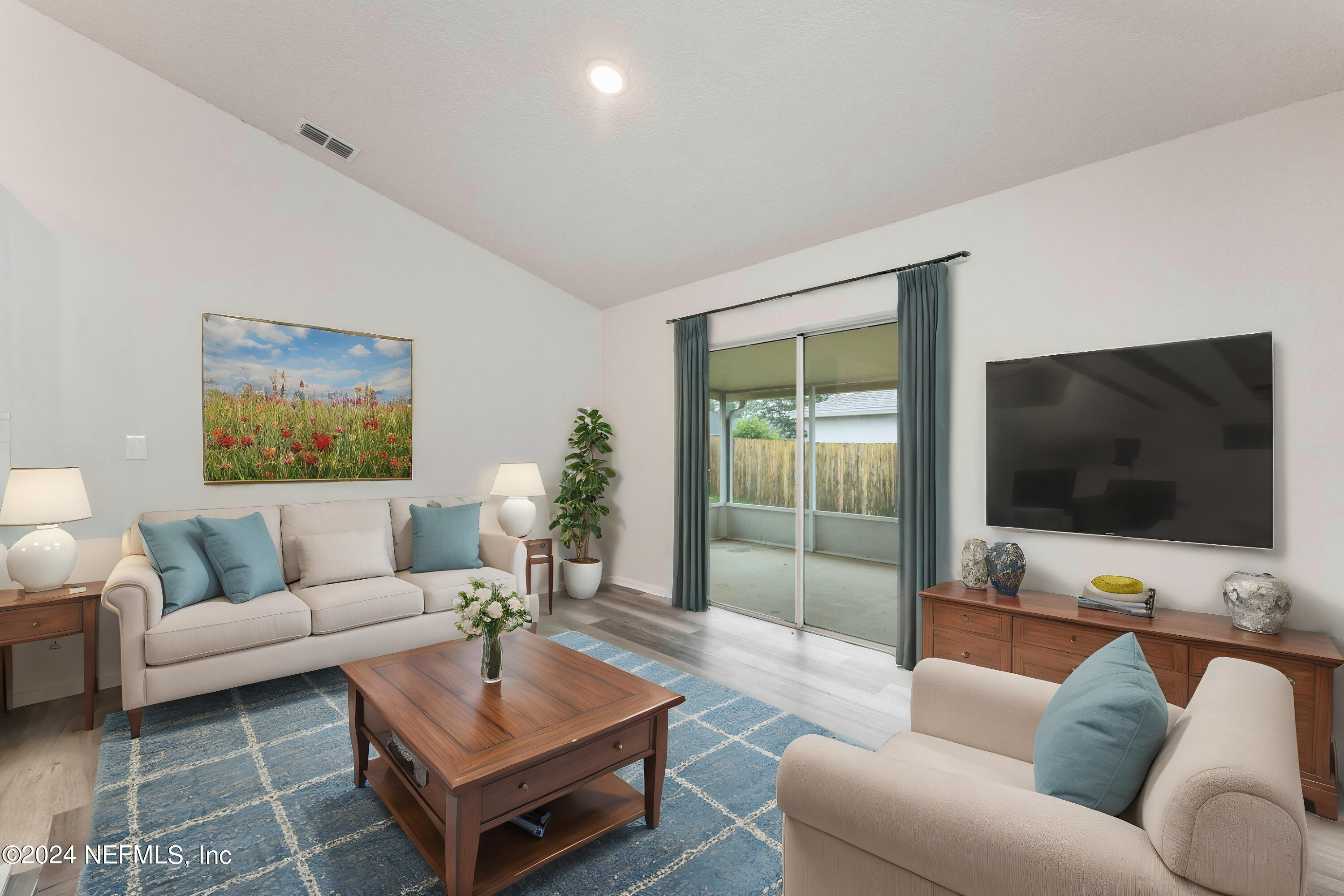 a living room with furniture and a flat screen tv