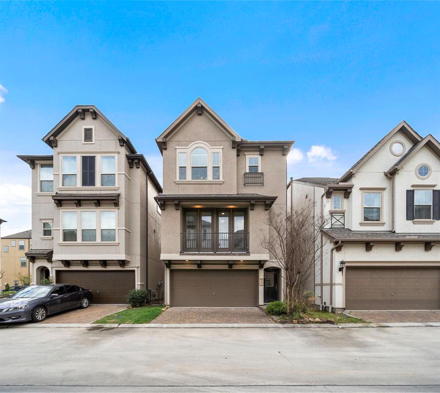 a view of a house with a yard and large parking space