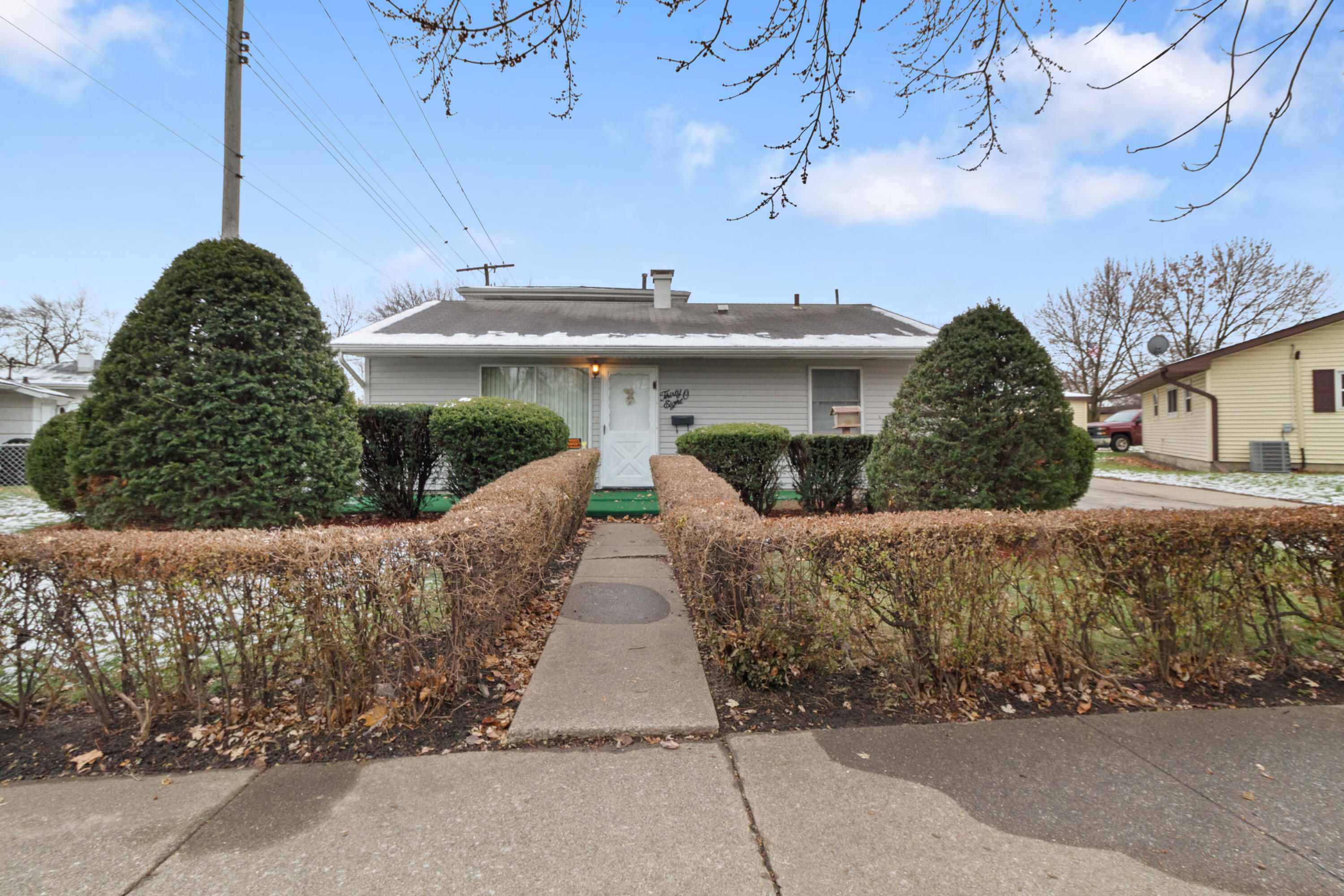 a front view of a house with a garden