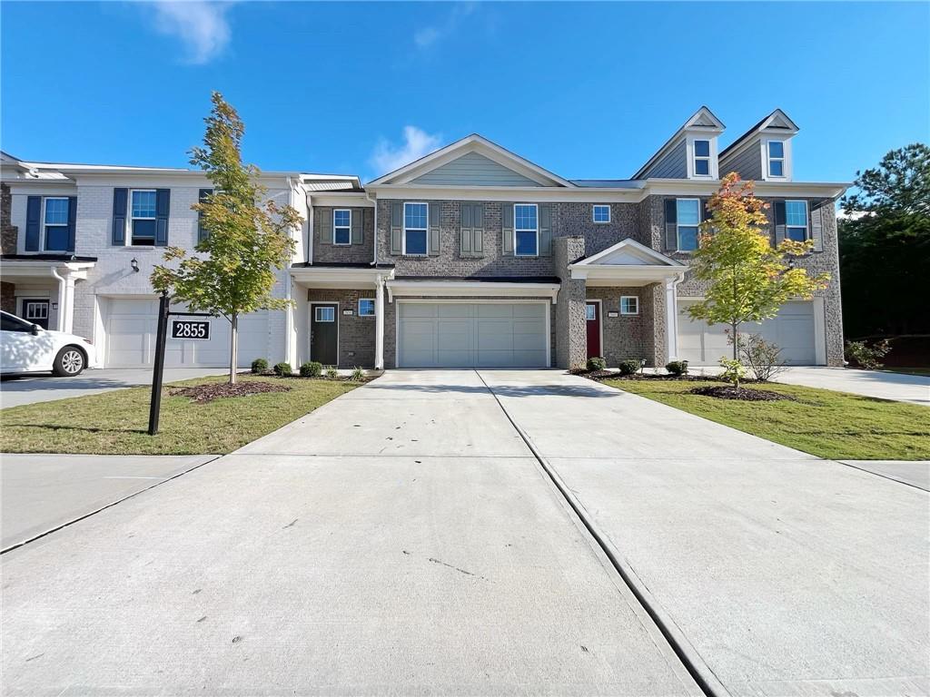 a front view of a house with a yard