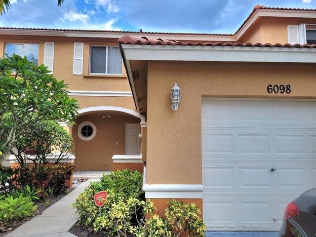 a front view of a house with garage