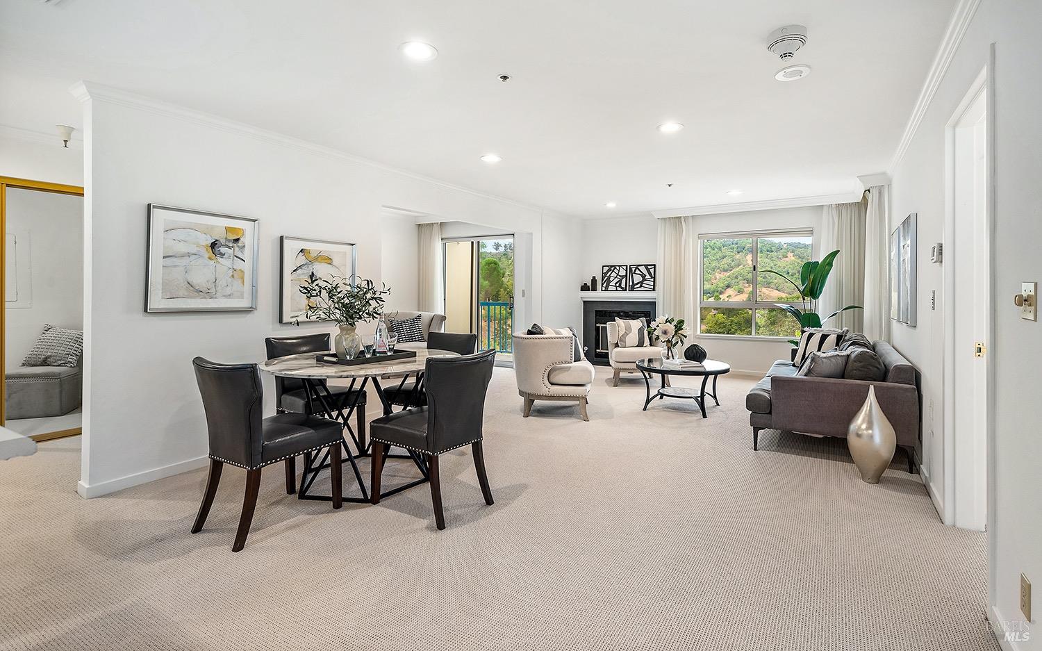 a view of a dining room with furniture and a livingroom