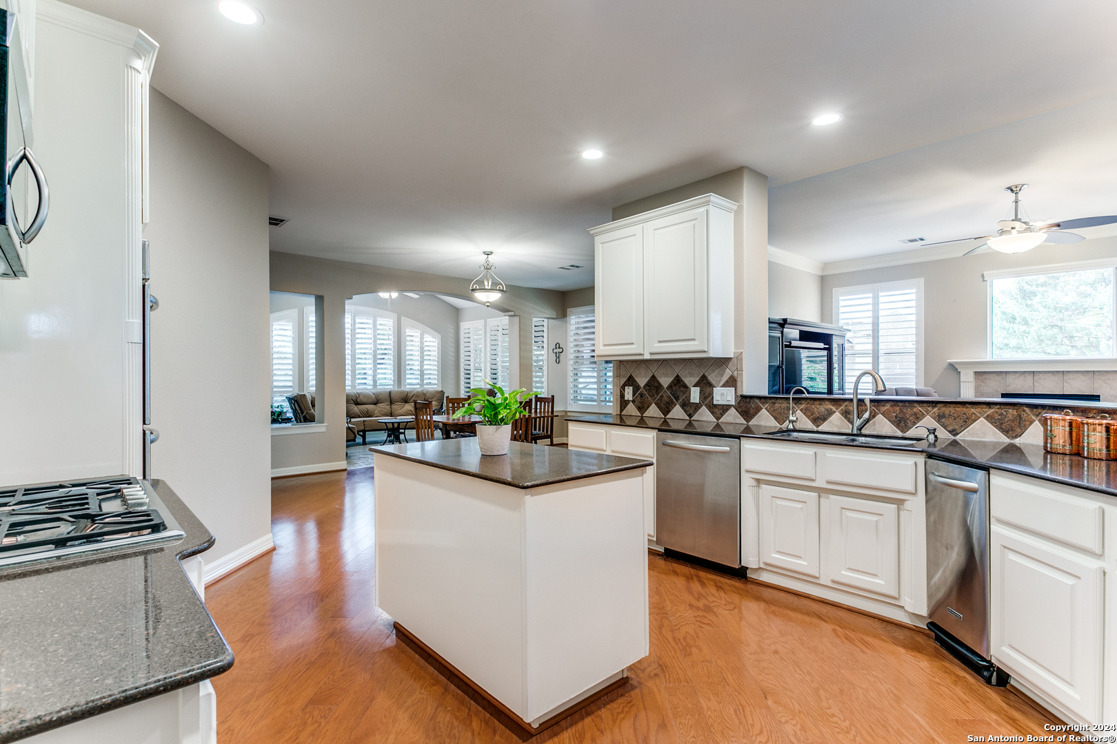 a kitchen with stainless steel appliances granite countertop a stove and a sink