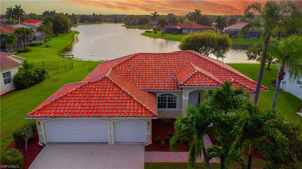 View of front of house featuring a water view and a yard