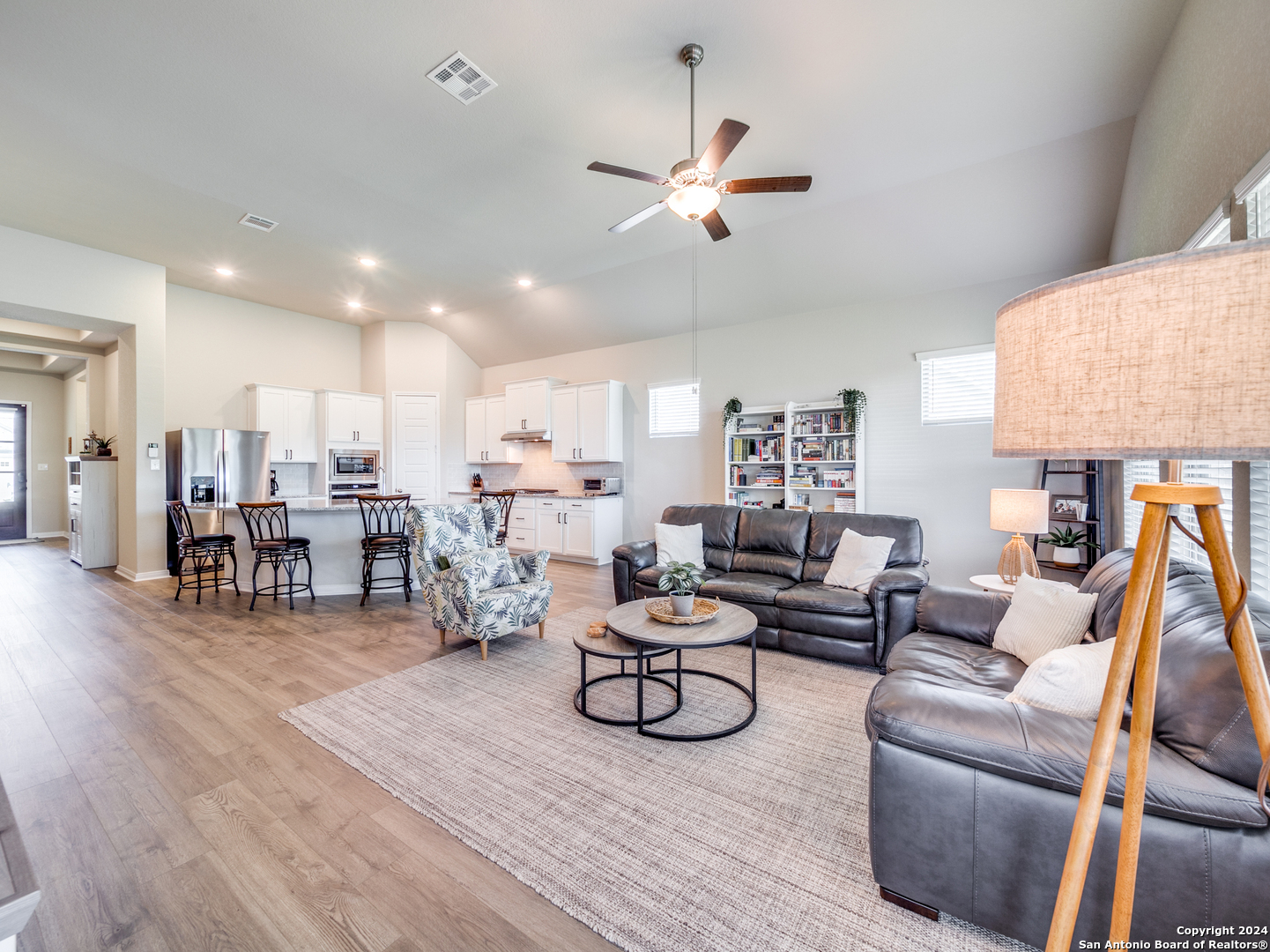 a living room with furniture and kitchen view