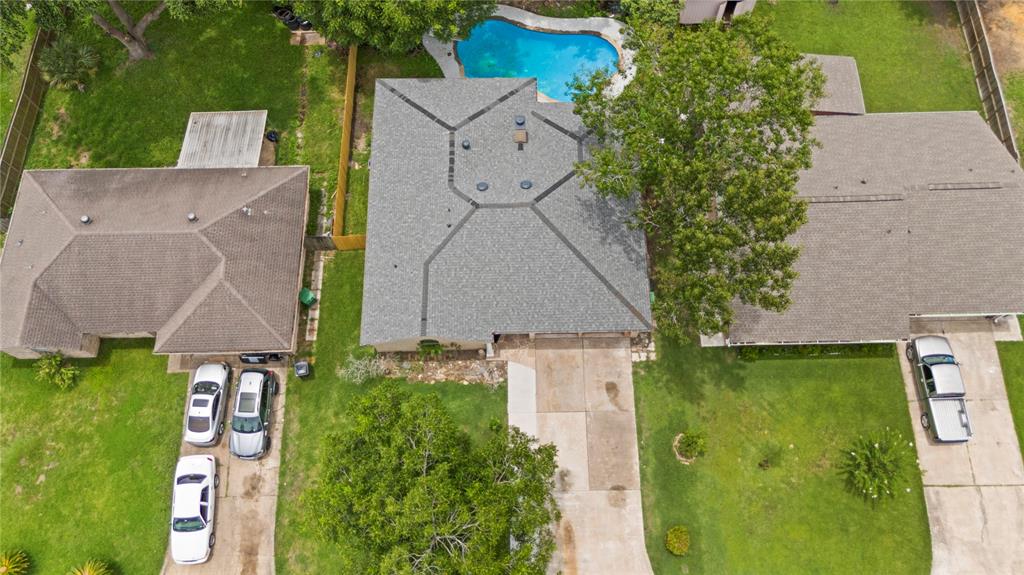 an aerial view of a house with a yard basket ball court and outdoor seating